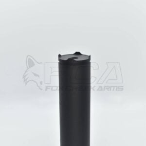 Black cylindrical rifle suppressor standing upright against a light background in a studio setting.